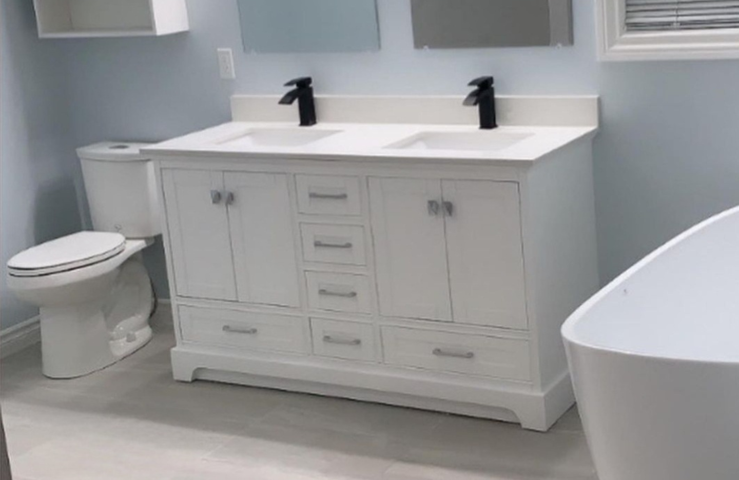 A white bathroom with a tub and sink.