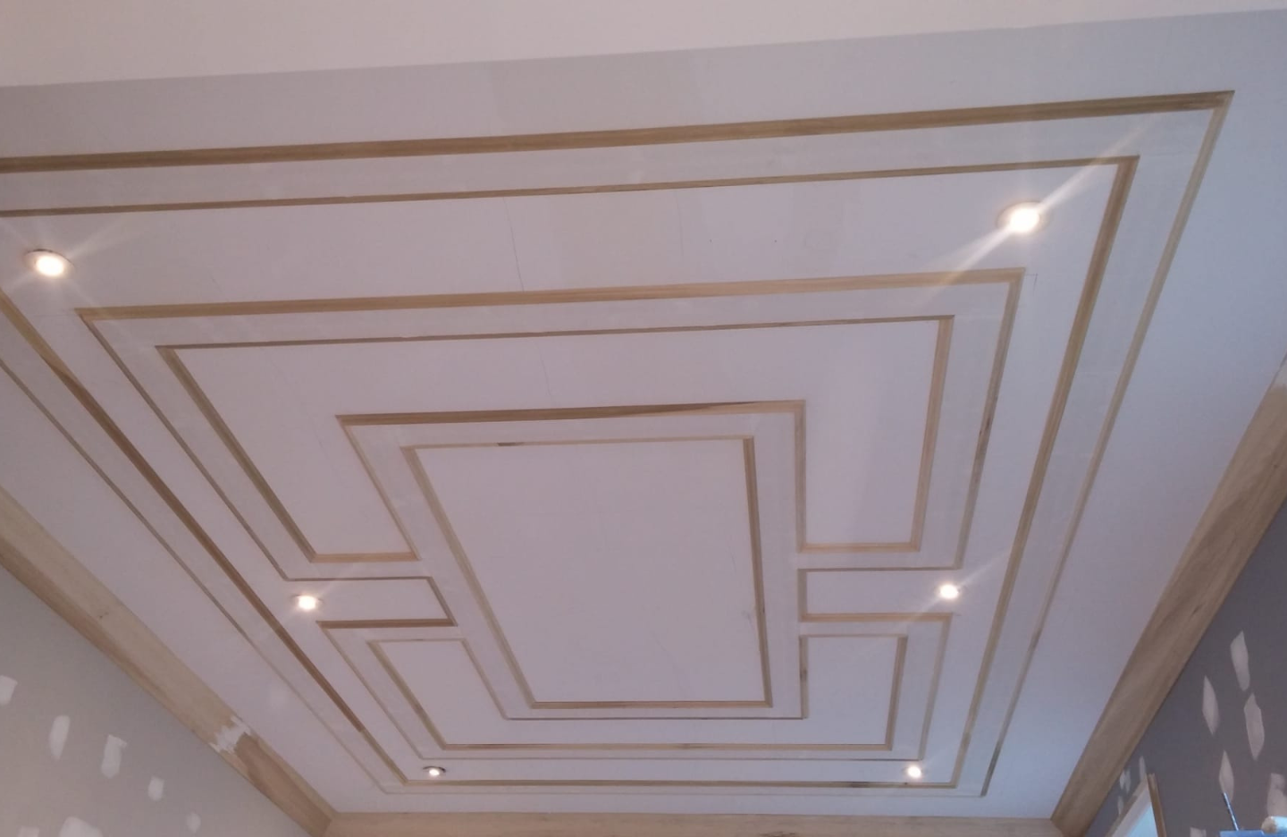 A room with a ceiling that is being painted.