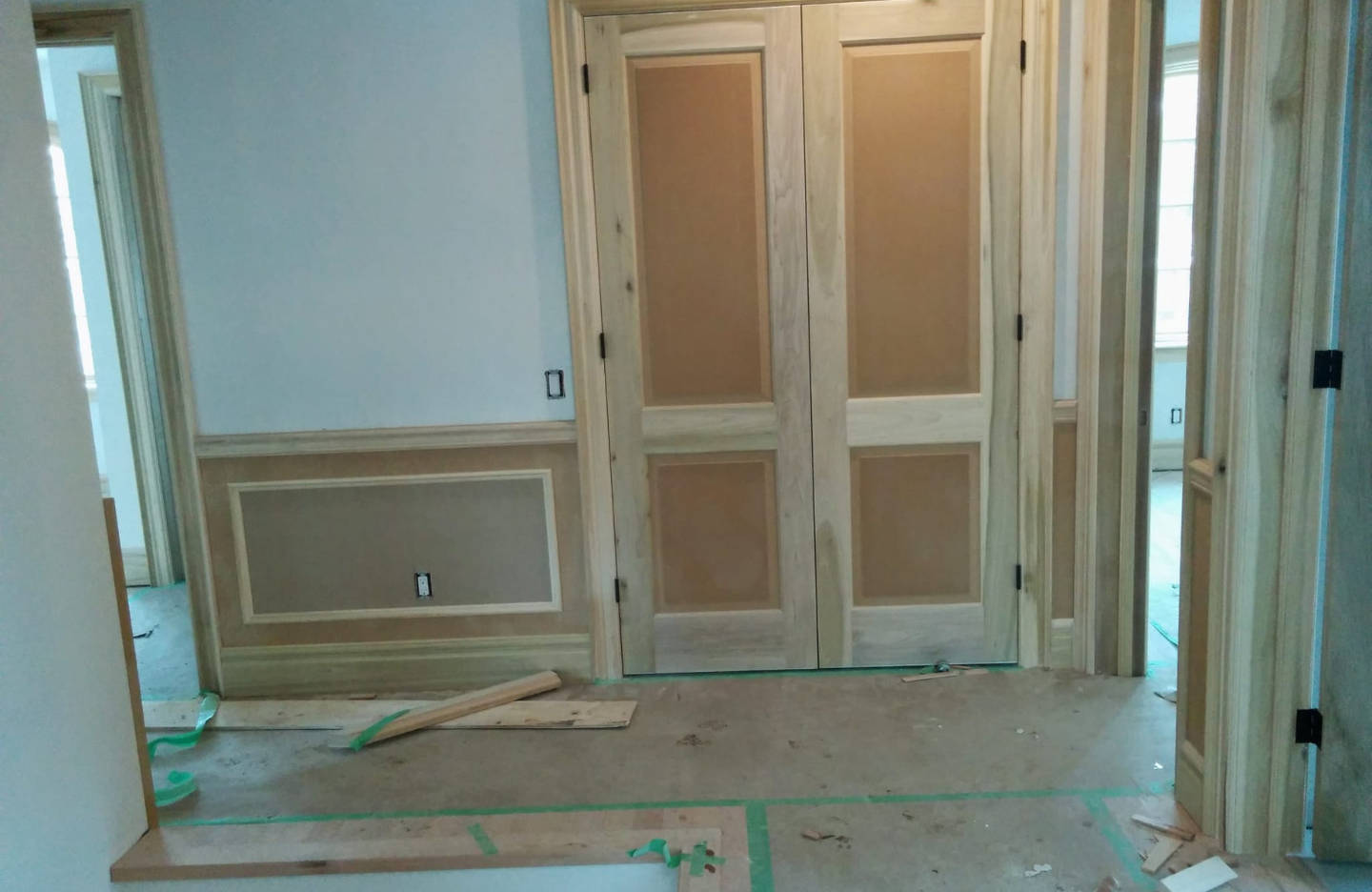 A room that is being remodeled with wooden doors.